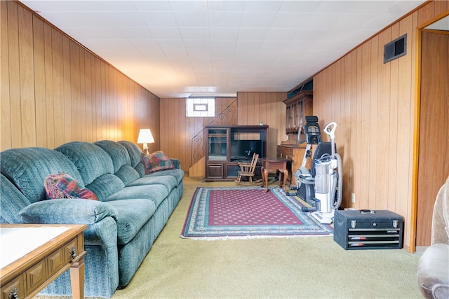 carpeted living room featuring wooden walls