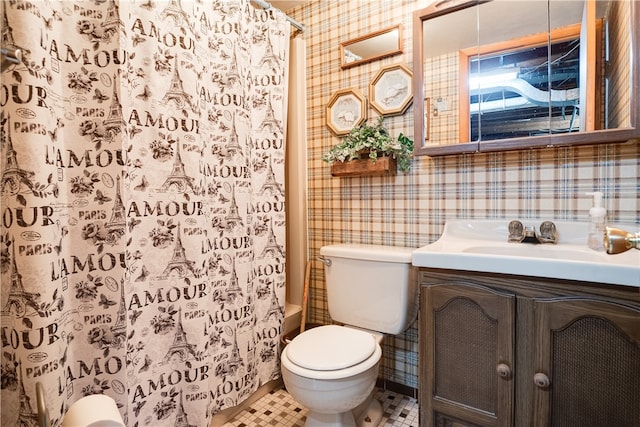 full bathroom with toilet, shower / bath combo with shower curtain, vanity, and tile patterned flooring