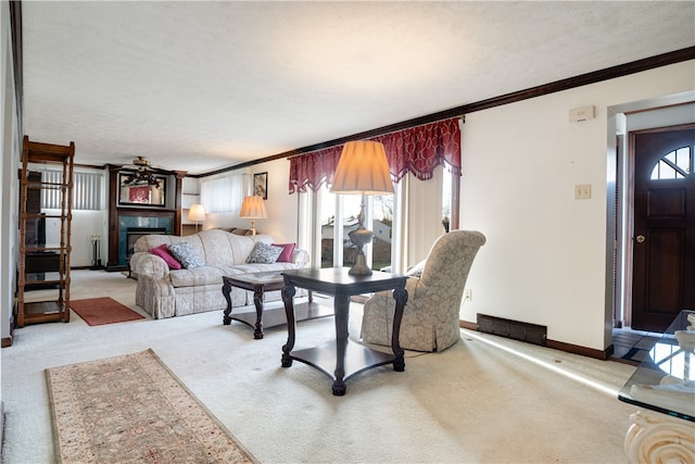 carpeted living room featuring ceiling fan, ornamental molding, and a textured ceiling