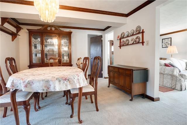 carpeted dining room with crown molding and a chandelier