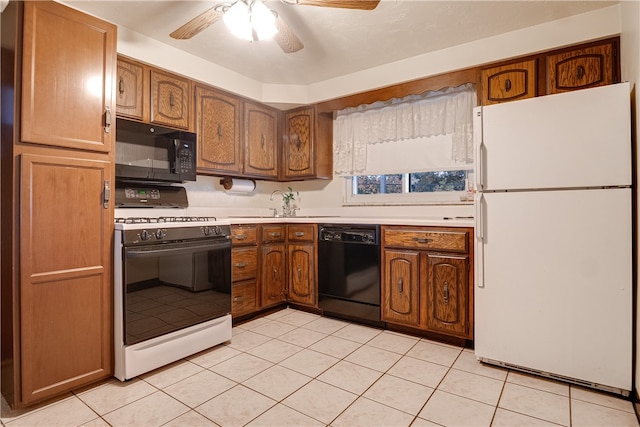 kitchen with black appliances, light tile patterned floors, sink, and ceiling fan