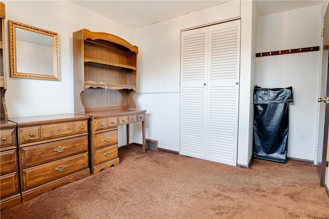 bedroom featuring light carpet and a closet