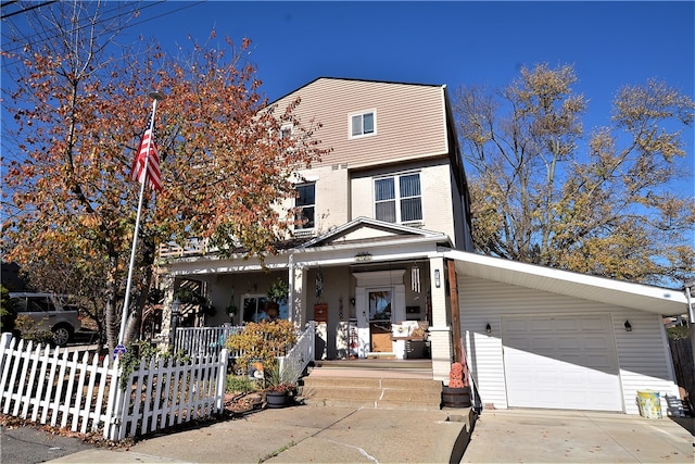 view of front of home with covered porch and a garage