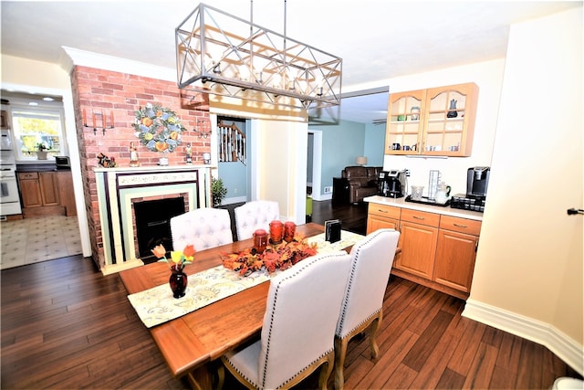 dining room featuring dark hardwood / wood-style floors, a brick fireplace, and ornamental molding