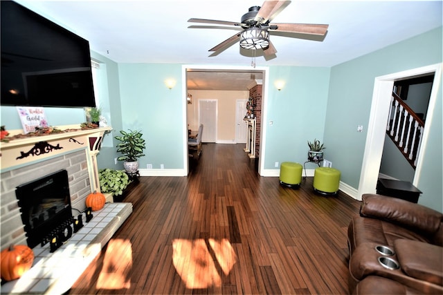 living room featuring ceiling fan and dark hardwood / wood-style flooring