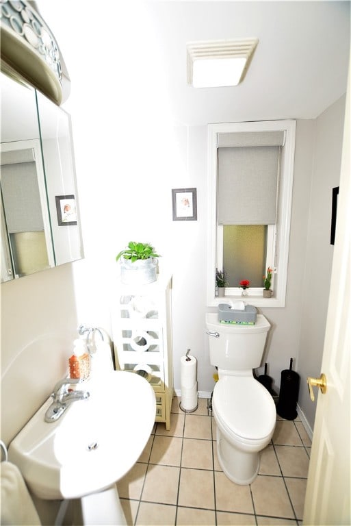 bathroom featuring tile patterned flooring and toilet