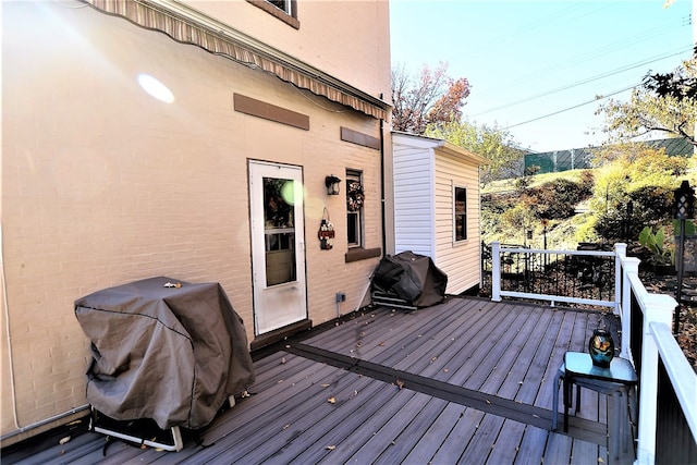 wooden terrace featuring a grill