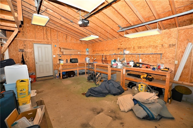 garage featuring a workshop area and a garage door opener