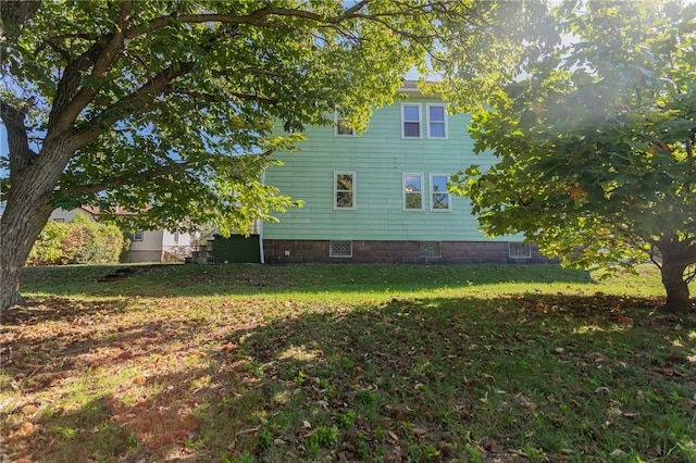 view of side of property with a lawn