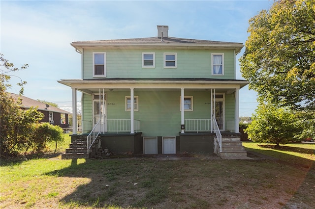 view of front of home with covered porch and a front yard