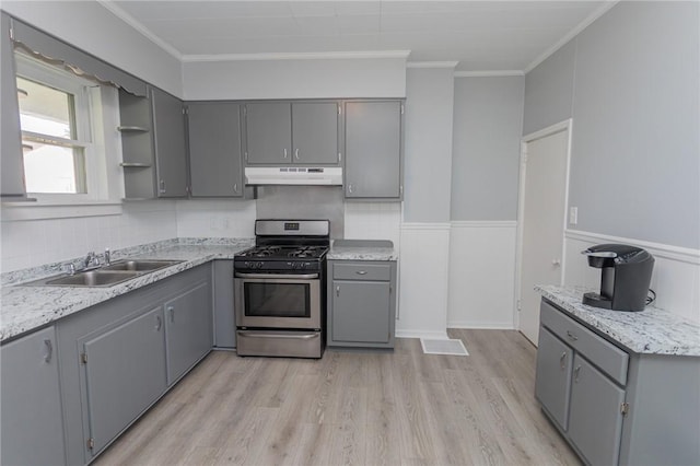 205 Woodlawn Ave, Connellsville, PA 15425 - kitchen with gas stove, gray cabinets, under cabinet range hood, a sink, and open shelves