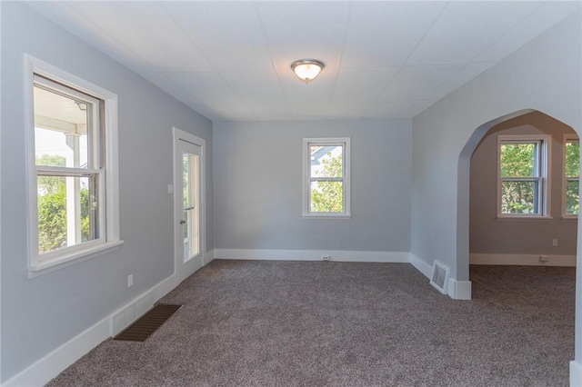 205 Woodlawn Ave, Connellsville, PA 15425 - unfurnished room featuring plenty of natural light, arched walkways, and carpet floors
