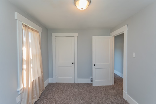 unfurnished bedroom featuring a closet and carpet