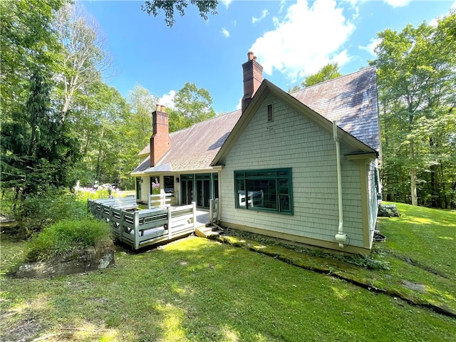 back of house featuring a yard and a wooden deck