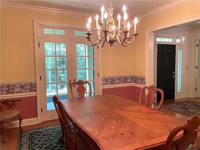 1197 Bankson Rd, Pa, PA 16301 - dining space featuring french doors, wood finished floors, ornamental molding, a chandelier, and a wealth of natural light