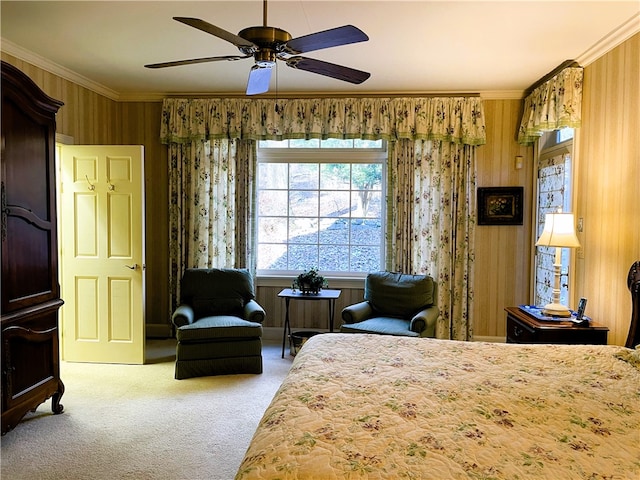 bedroom with ornamental molding, wooden walls, carpet, and ceiling fan