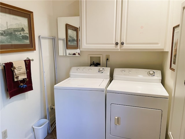 washroom with cabinets and washer and clothes dryer