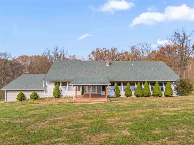 view of front of property with a patio and a front lawn