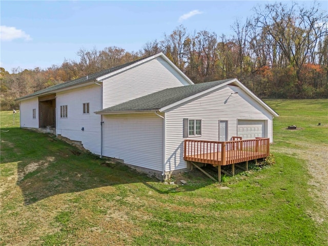 rear view of property featuring a deck and a lawn