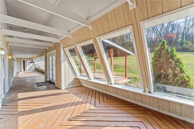 unfurnished sunroom featuring a wealth of natural light and beam ceiling