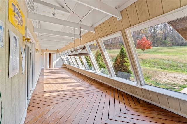 unfurnished sunroom with vaulted ceiling with beams