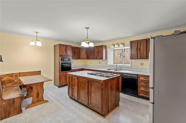 kitchen with a center island, black appliances, decorative light fixtures, and an inviting chandelier