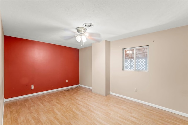 empty room featuring a textured ceiling, light hardwood / wood-style flooring, and ceiling fan