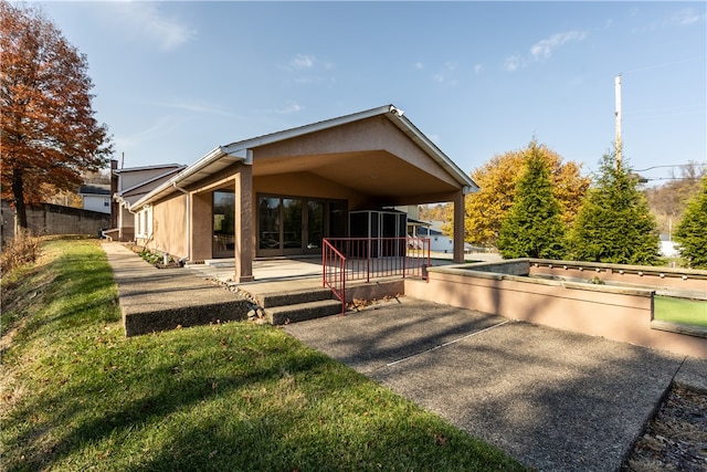 rear view of property featuring a patio and a sunroom