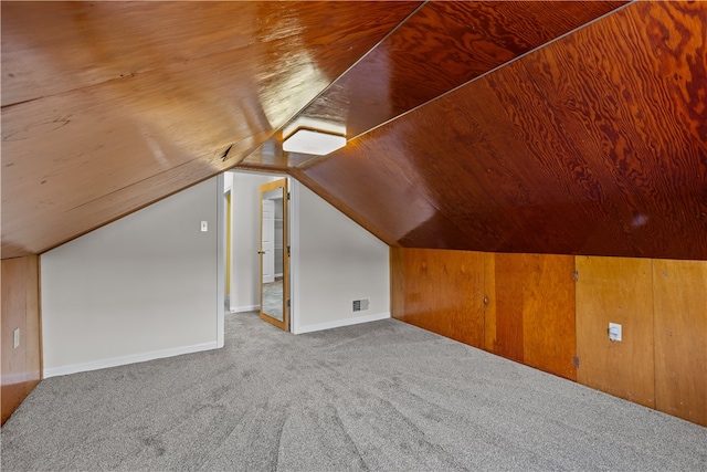 additional living space featuring light carpet, wooden ceiling, and lofted ceiling