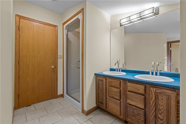 bathroom with vanity, a shower with shower door, and tile patterned flooring