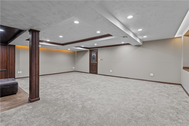 basement featuring crown molding, a textured ceiling, and light colored carpet