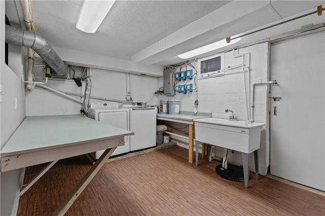 washroom with washer and dryer, hardwood / wood-style flooring, and a textured ceiling