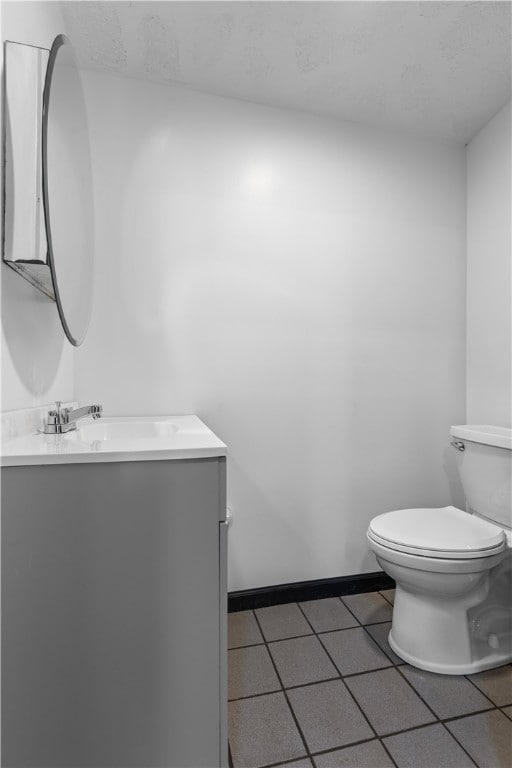 bathroom featuring vanity, toilet, and tile patterned floors