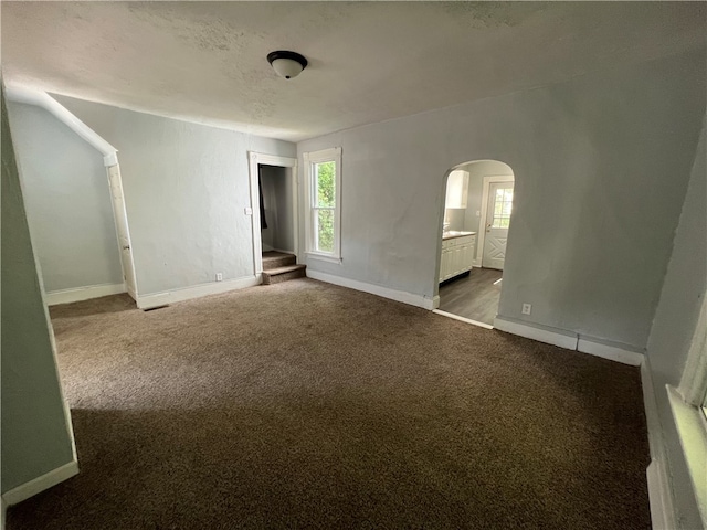 unfurnished room featuring a textured ceiling and carpet