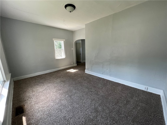 empty room with dark carpet