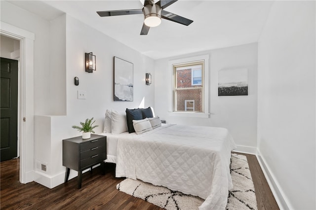 bedroom with dark hardwood / wood-style flooring and ceiling fan