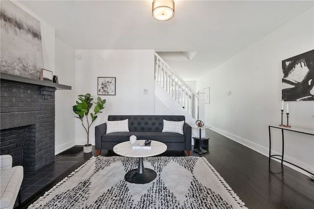 living room featuring dark hardwood / wood-style floors and a fireplace