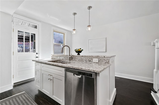 kitchen with dark wood-type flooring, hanging light fixtures, sink, stainless steel dishwasher, and white cabinetry