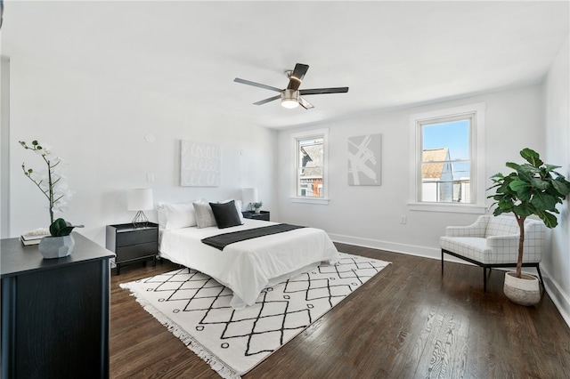 bedroom with dark hardwood / wood-style flooring, multiple windows, and ceiling fan