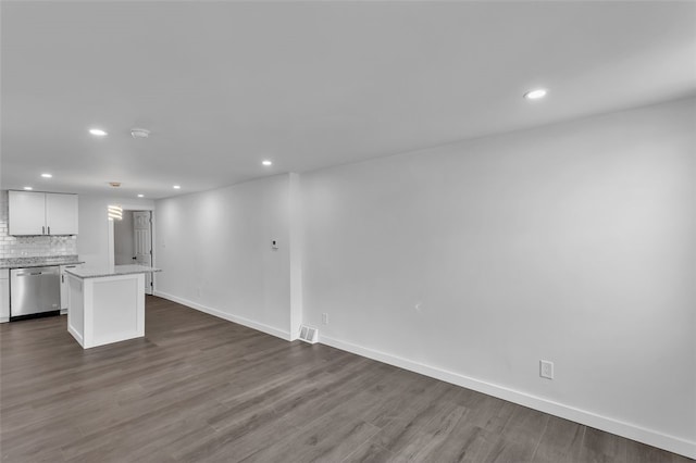 unfurnished living room with dark wood-type flooring