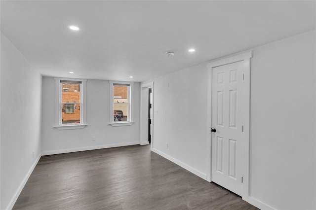 spare room with dark hardwood / wood-style floors