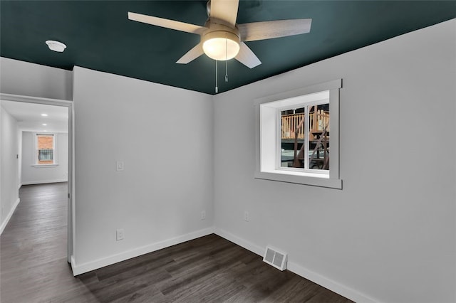 unfurnished room with dark hardwood / wood-style floors and ceiling fan