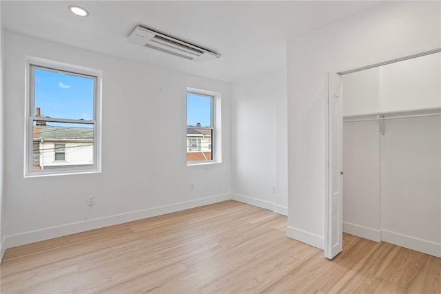 unfurnished bedroom featuring a closet and light hardwood / wood-style floors