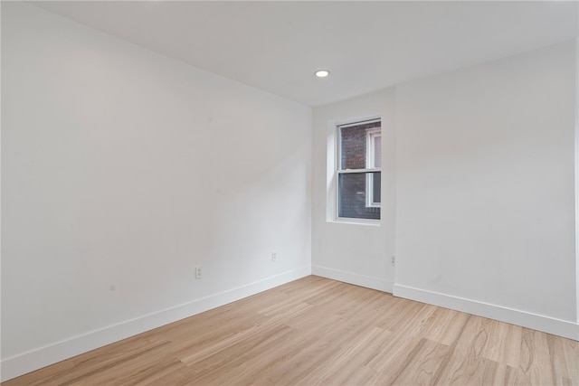 unfurnished room with light wood-type flooring