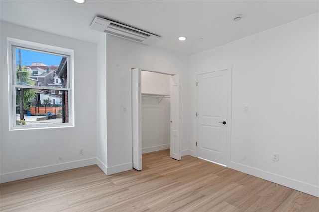 unfurnished bedroom with a closet and light wood-type flooring