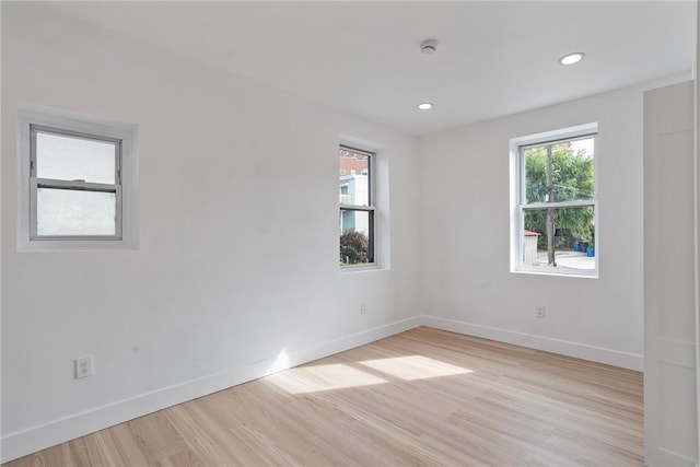 unfurnished room with light hardwood / wood-style floors