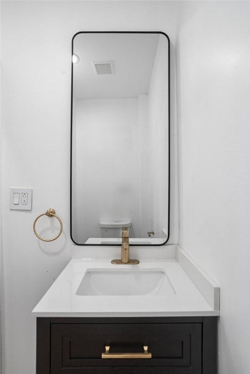 bathroom with vanity and toilet