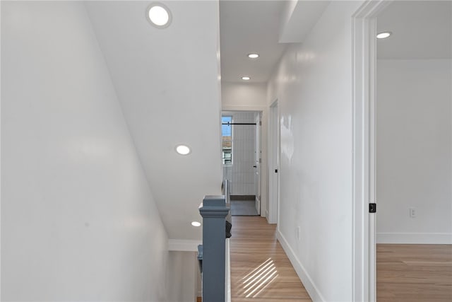 hallway with light hardwood / wood-style flooring