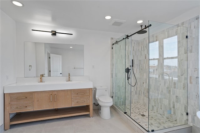 bathroom with vanity, toilet, tile patterned floors, and a shower with door