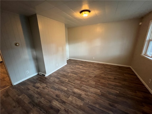 unfurnished room featuring dark hardwood / wood-style flooring